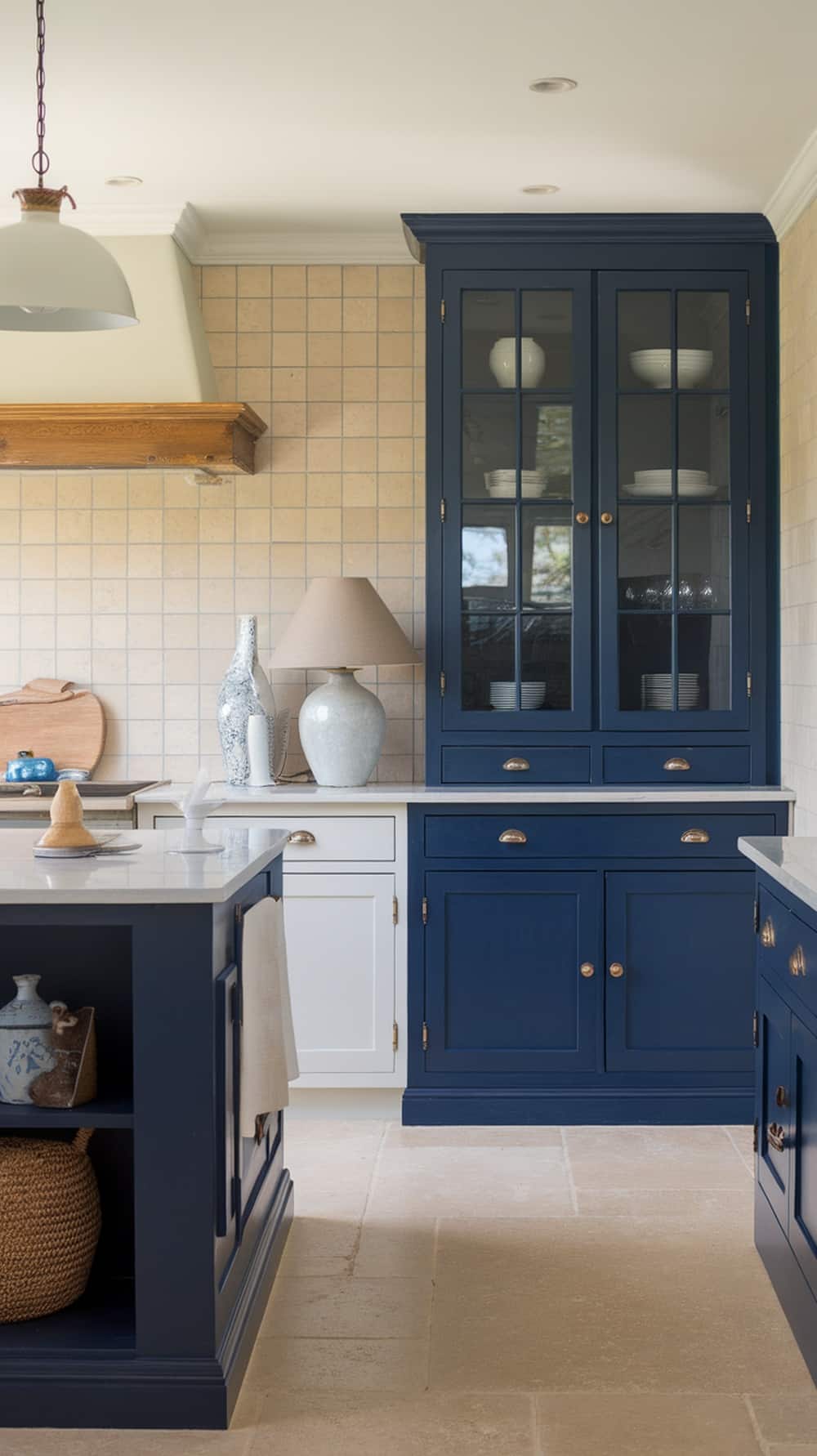 Coastal inspired kitchen with navy blue cabinets, white accents, and natural decor elements.