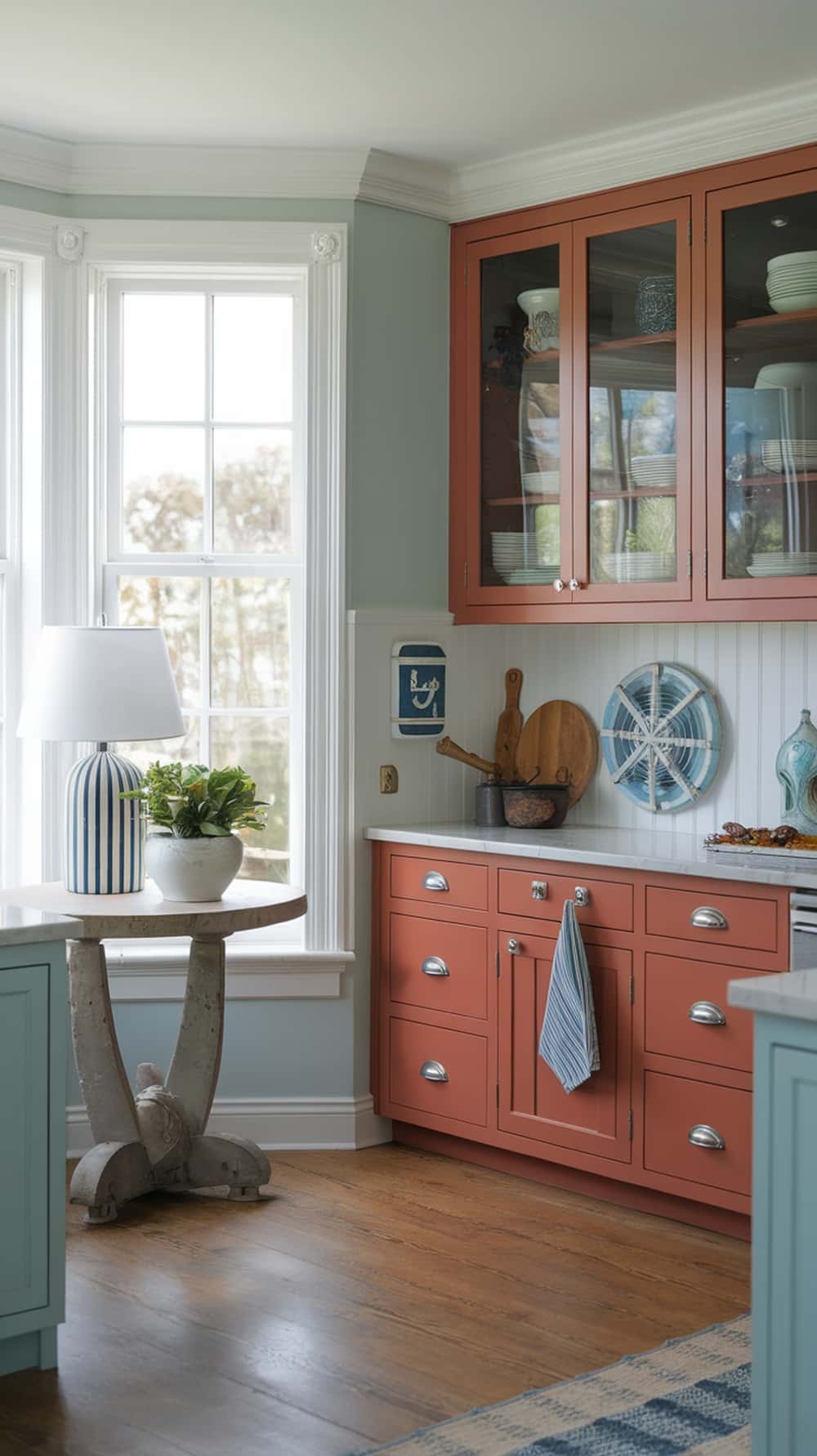 Coastal inspired kitchen with rust orange cabinets and light blue accents.