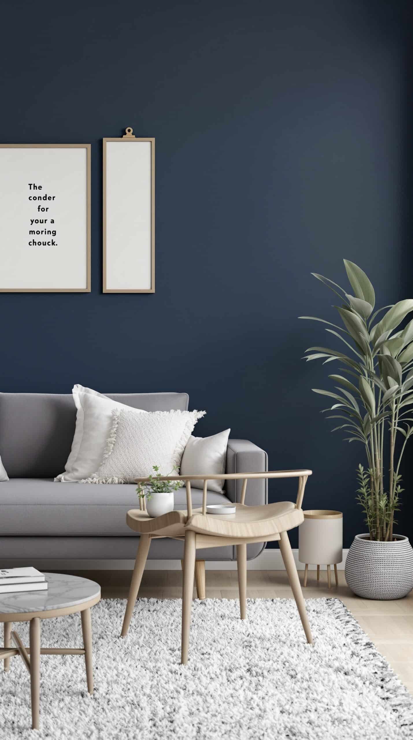 A living room featuring a navy blue accent wall, gray sofa with white pillows, and minimalist decor.