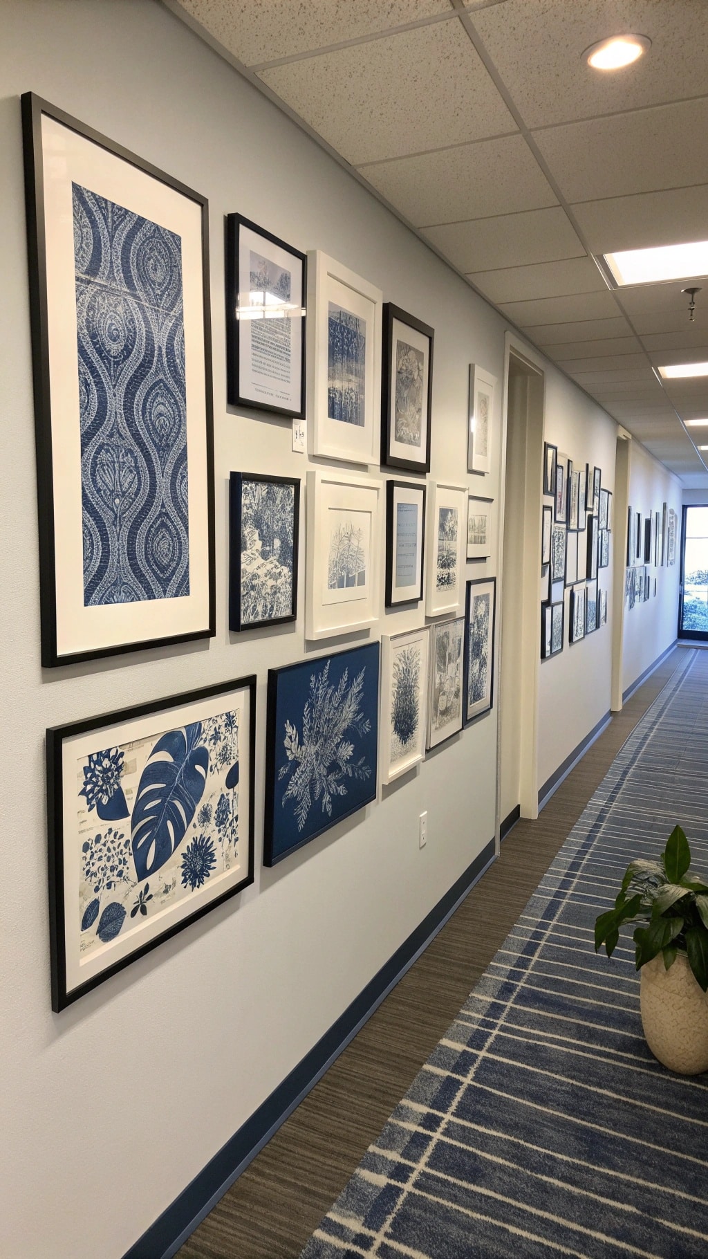 A hallway with navy blue themed wall art, featuring various framed prints and patterns.