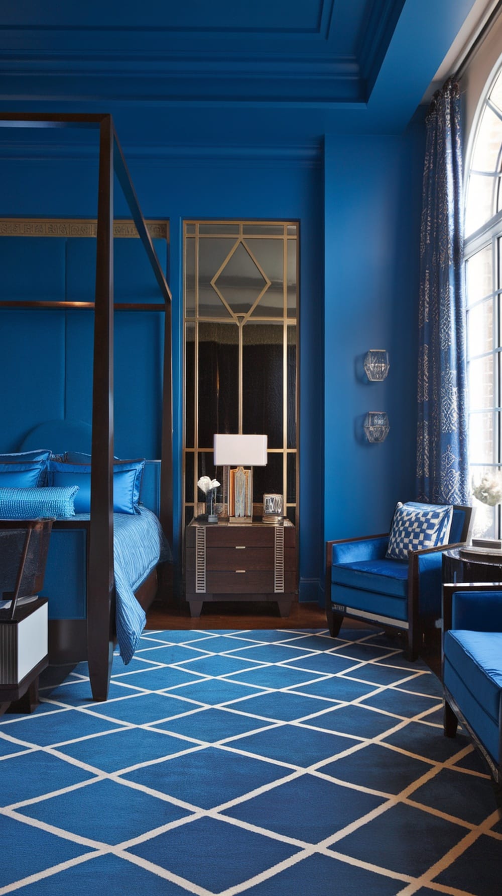 Art Deco blue bedroom featuring rich blue walls, a chandelier, and stylish furniture.