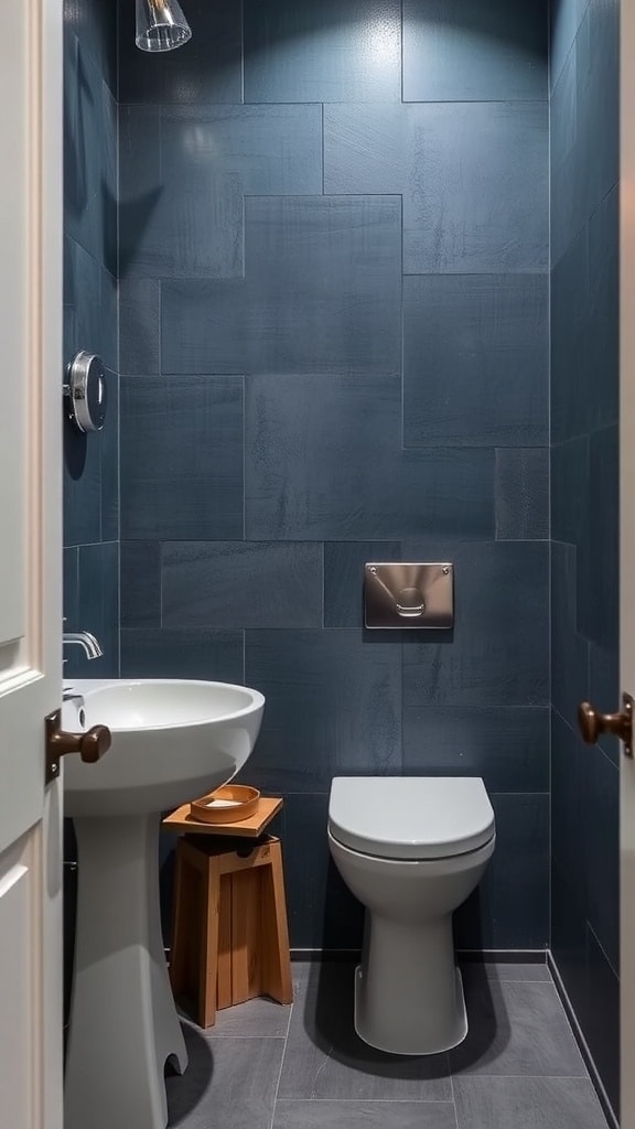 A small bathroom with slate blue textured walls and gold fixtures.