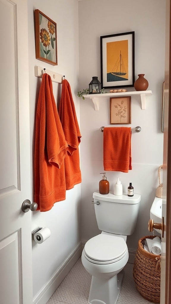 Small bathroom with rust orange towels and decor, featuring artwork and a woven basket.