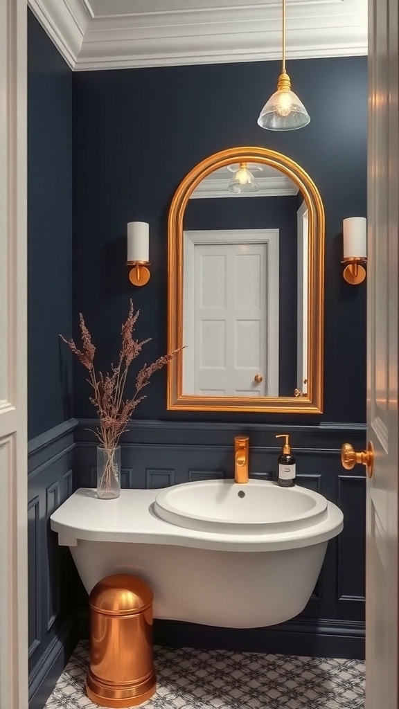 A luxurious navy blue bathroom with gold accents, featuring a round mirror, gold light fixtures, and a stylish waste bin.