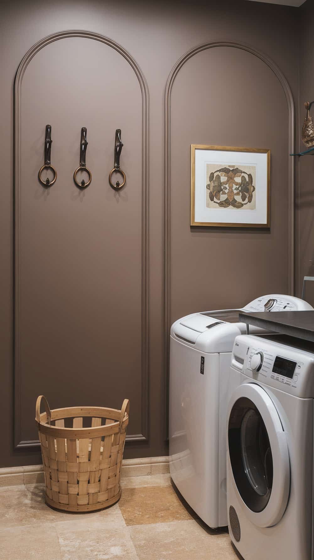 Laundry room with taupe accent wall, wooden basket, and stylish hooks.