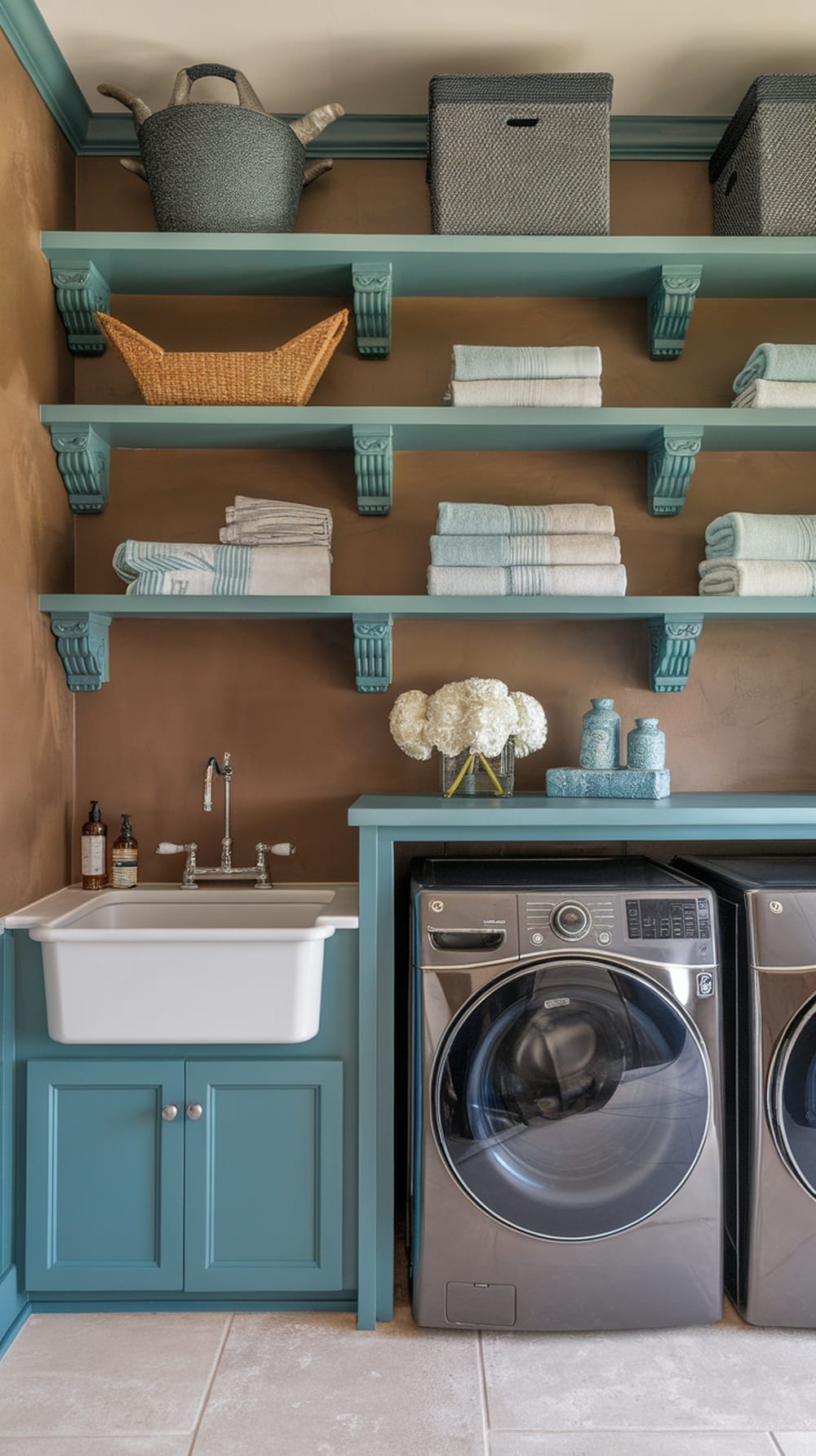Laundry room with open shelving in slate blue, featuring neatly arranged towels and decorative items.