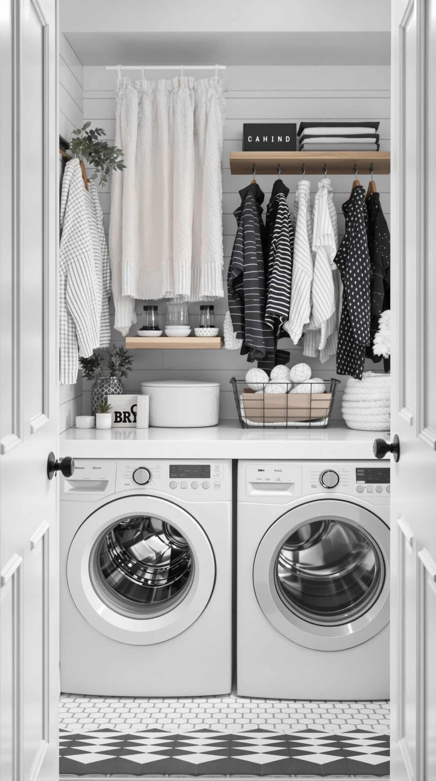 A minimalist laundry room featuring black and white textured fabrics, including striped shirts and soft curtains.