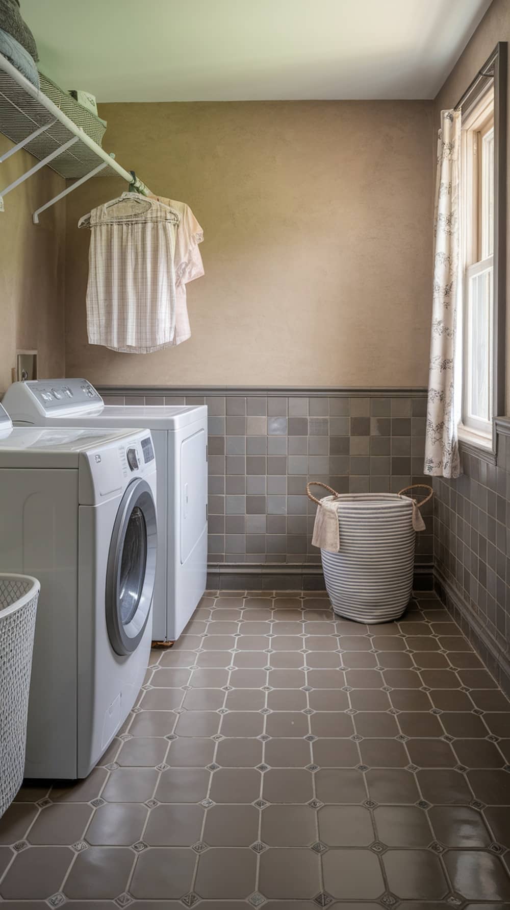 Laundry room with taupe and gray tile flooring, white appliances, and a cozy atmosphere.