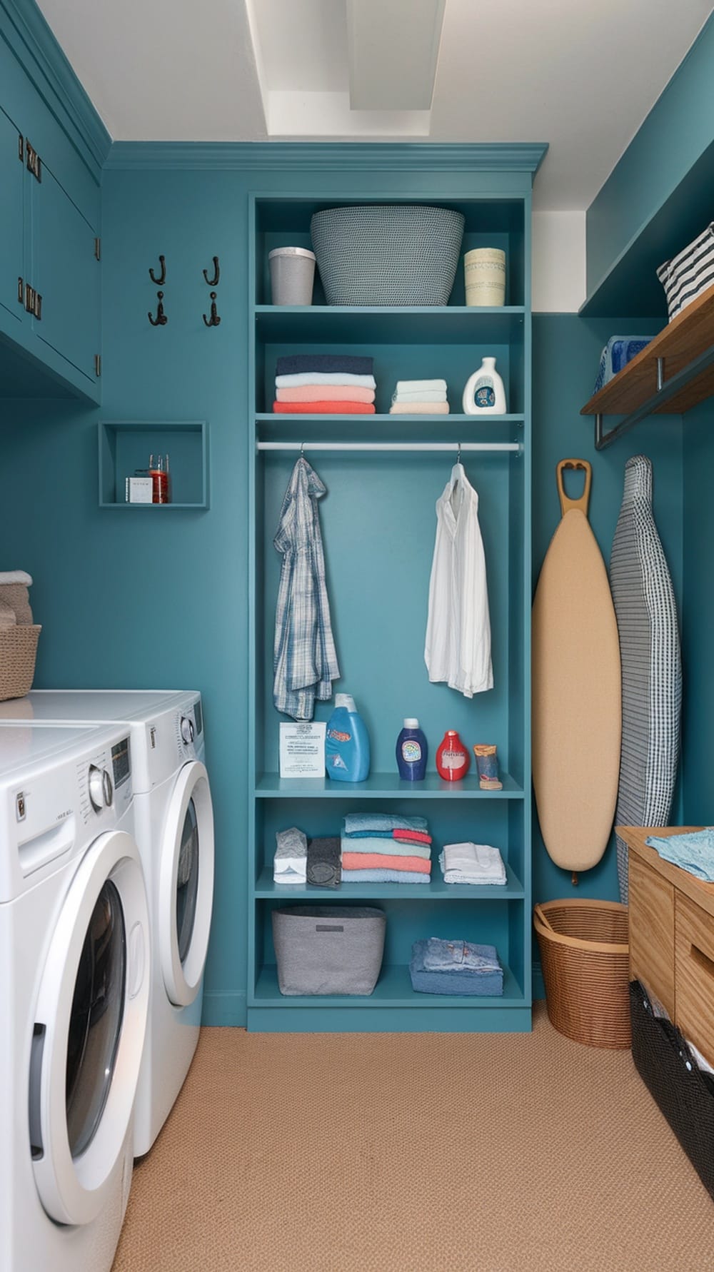 A stylish peacock blue laundry room featuring an integrated folding station with shelves and organized laundry supplies.