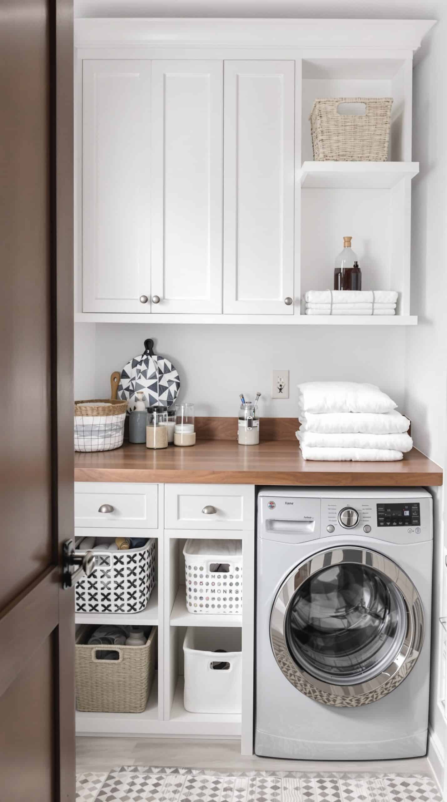 A tidy laundry room with a functional folding station, featuring a wooden countertop and organized storage.