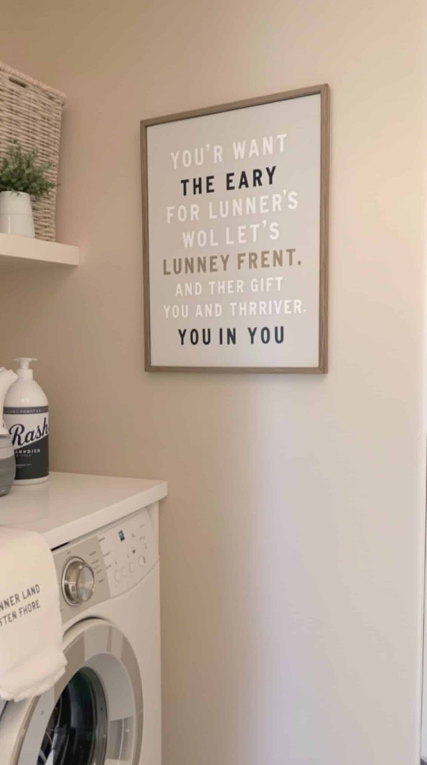Customized wall art in a beige laundry room featuring a playful message