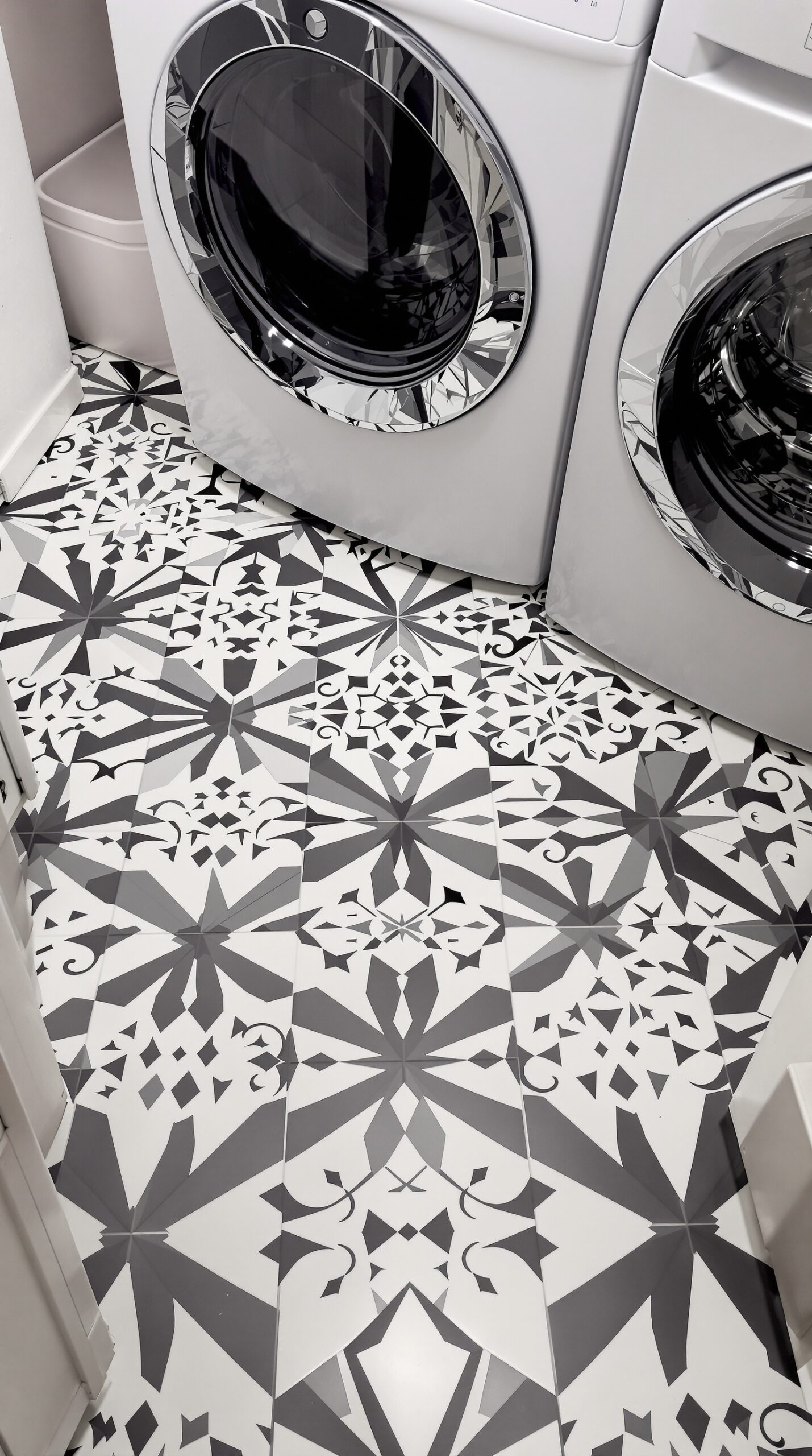 Chic black and white tile pattern in a laundry room with modern washing machines