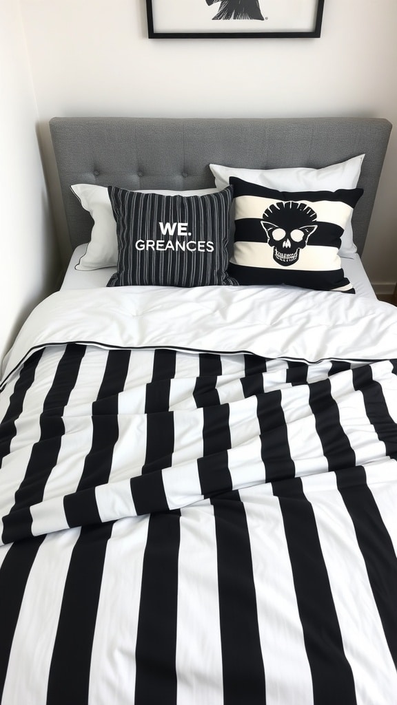 A bed with black and white striped bedding and decorative pillows featuring a skull design and text.