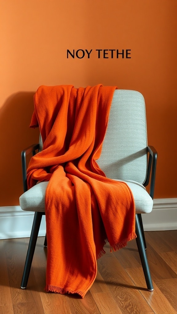 A rust orange throw blanket draped over a modern chair against an orange wall.